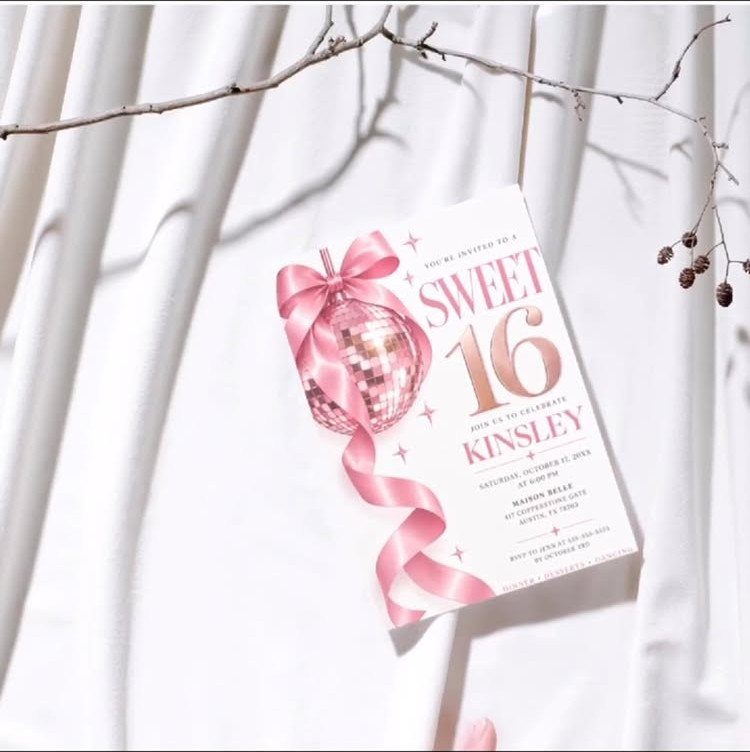 Pink Sweet 16 invitation with a disco ball and ribbon on white fabric
