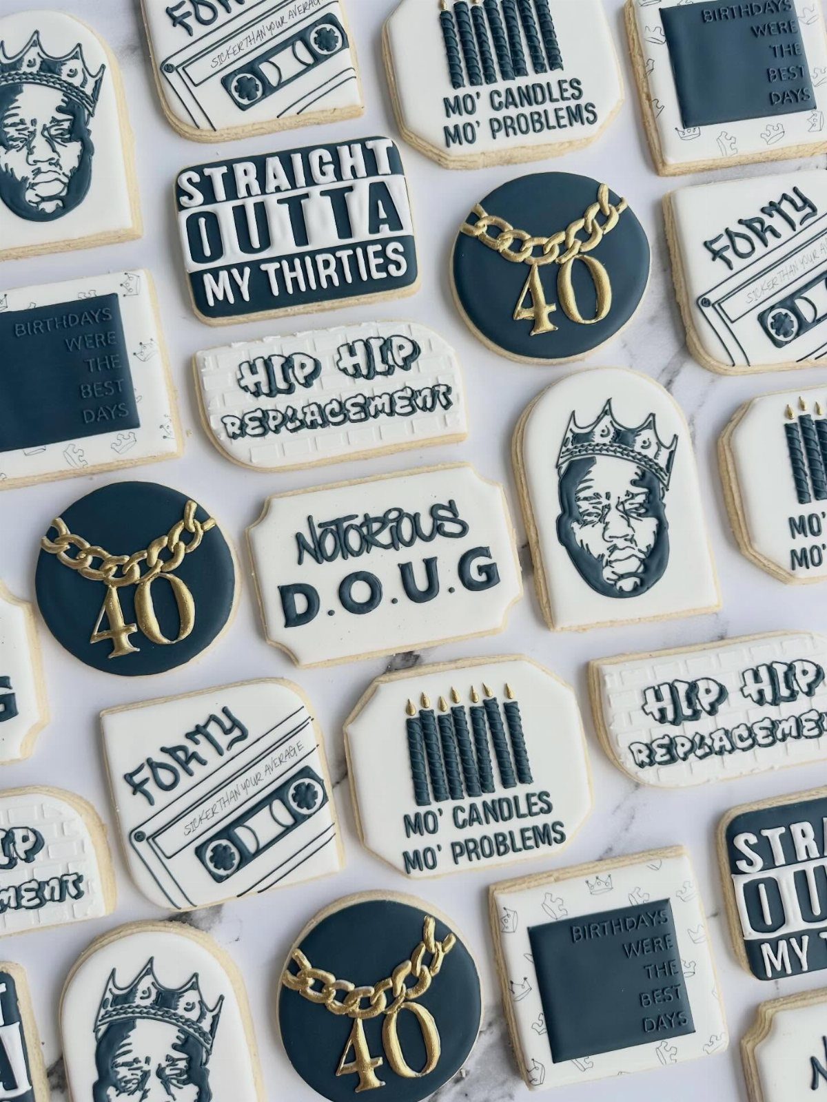 Decorated sugar cookies with faces, cassette tapes, and 40th birthday themed text.