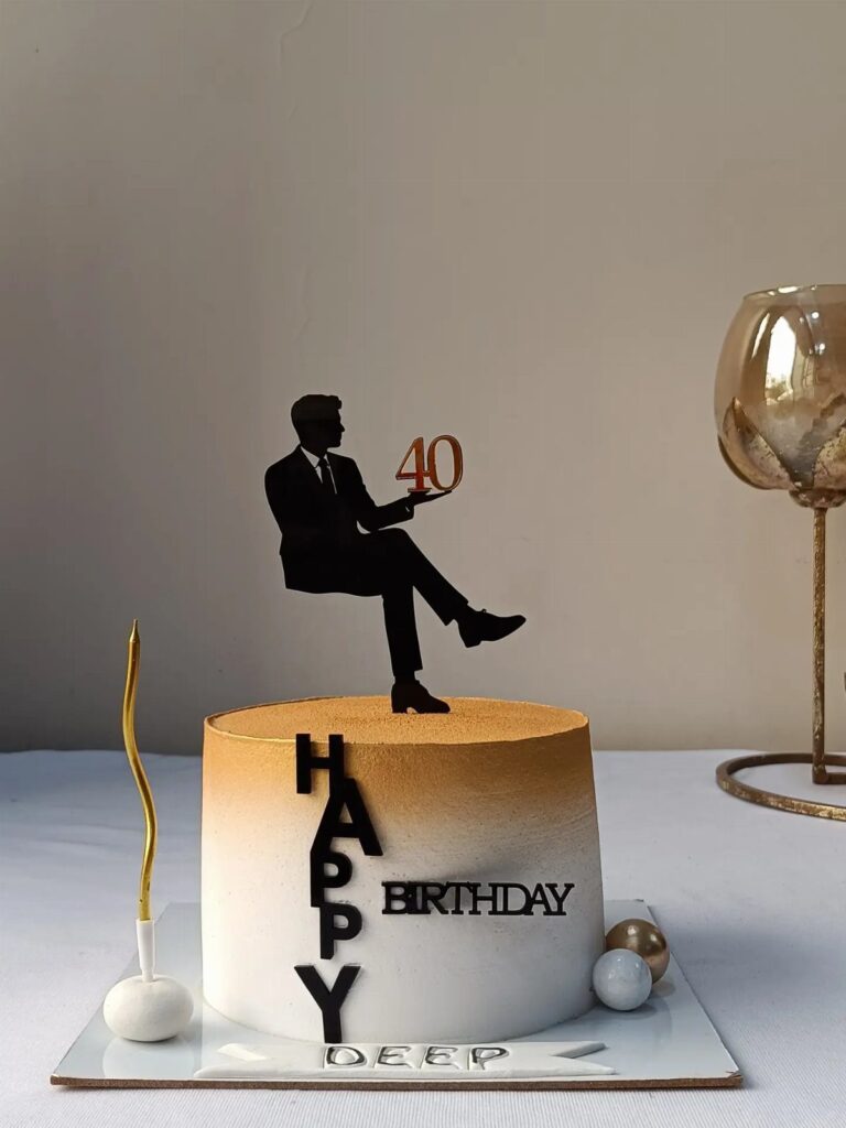 White and gold ombre birthday cake with a man silhouette topper holding number 40