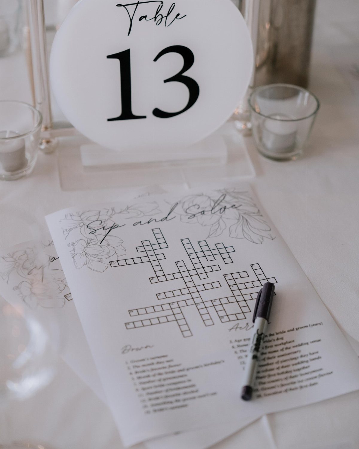 Crossword puzzle game on a white table next to a table number sign.